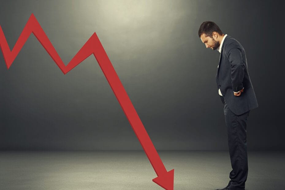 man looking at downturn graph